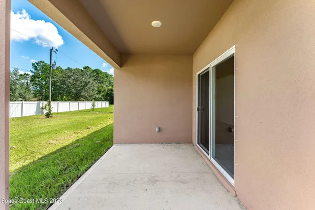 an aerial view of a house with swimming pool patio and outdoor seating