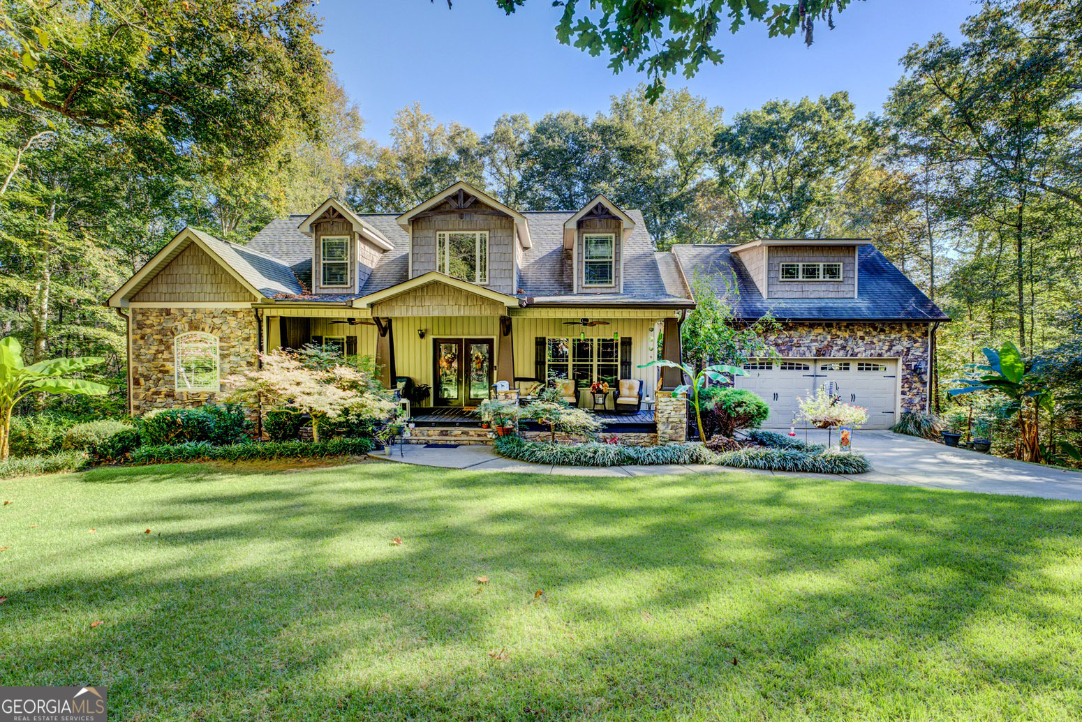 a view of a house with a yard and sitting area