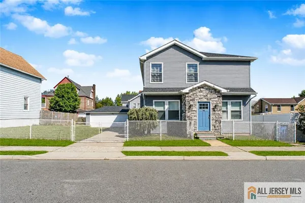 a view of a house with a yard patio and a table