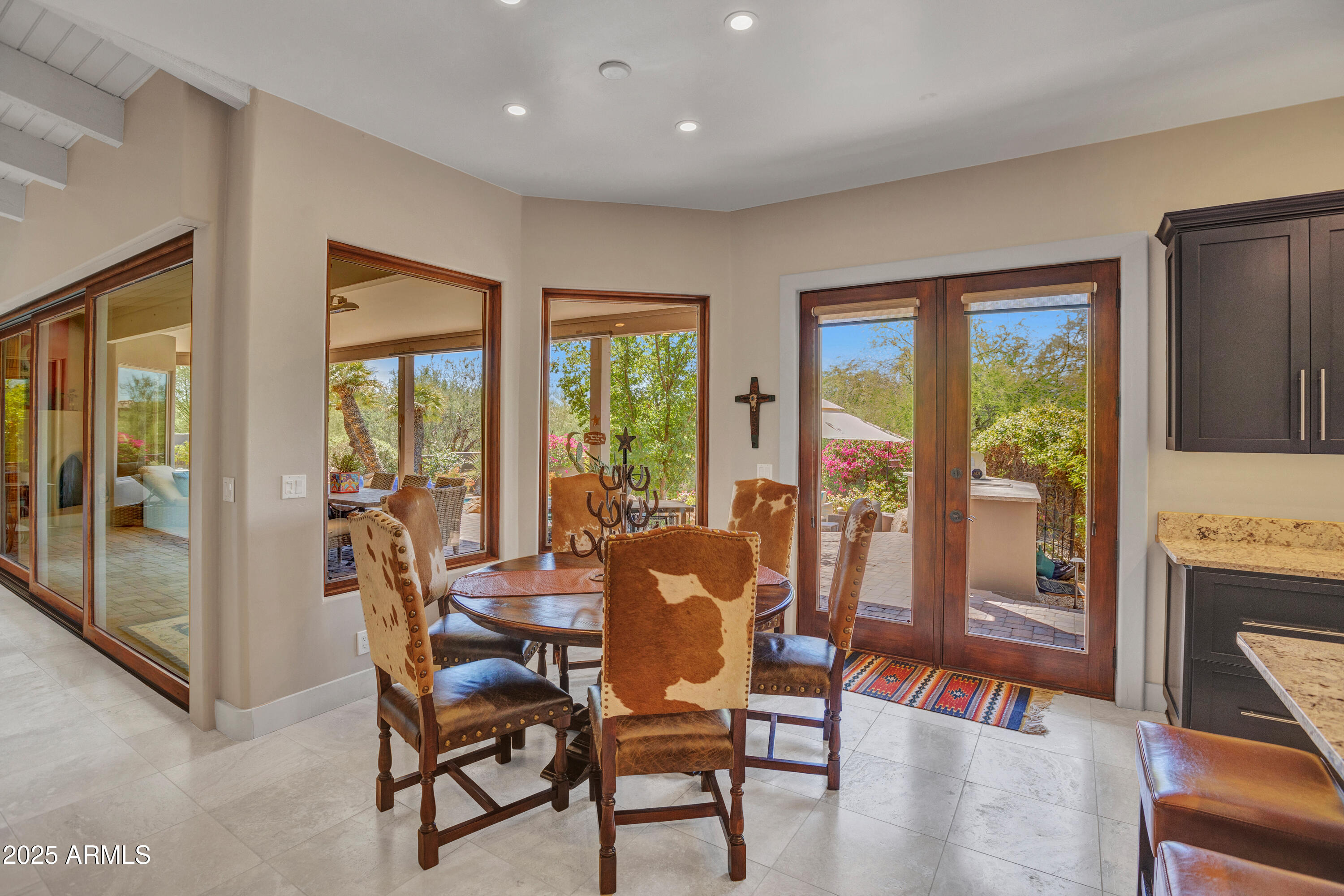 10040 East Happy Valley Road, Unit 268 Scottsdale, AZ 85255 - Photo 10 of 40 a view of a dining room with furniture large windows and wooden floor