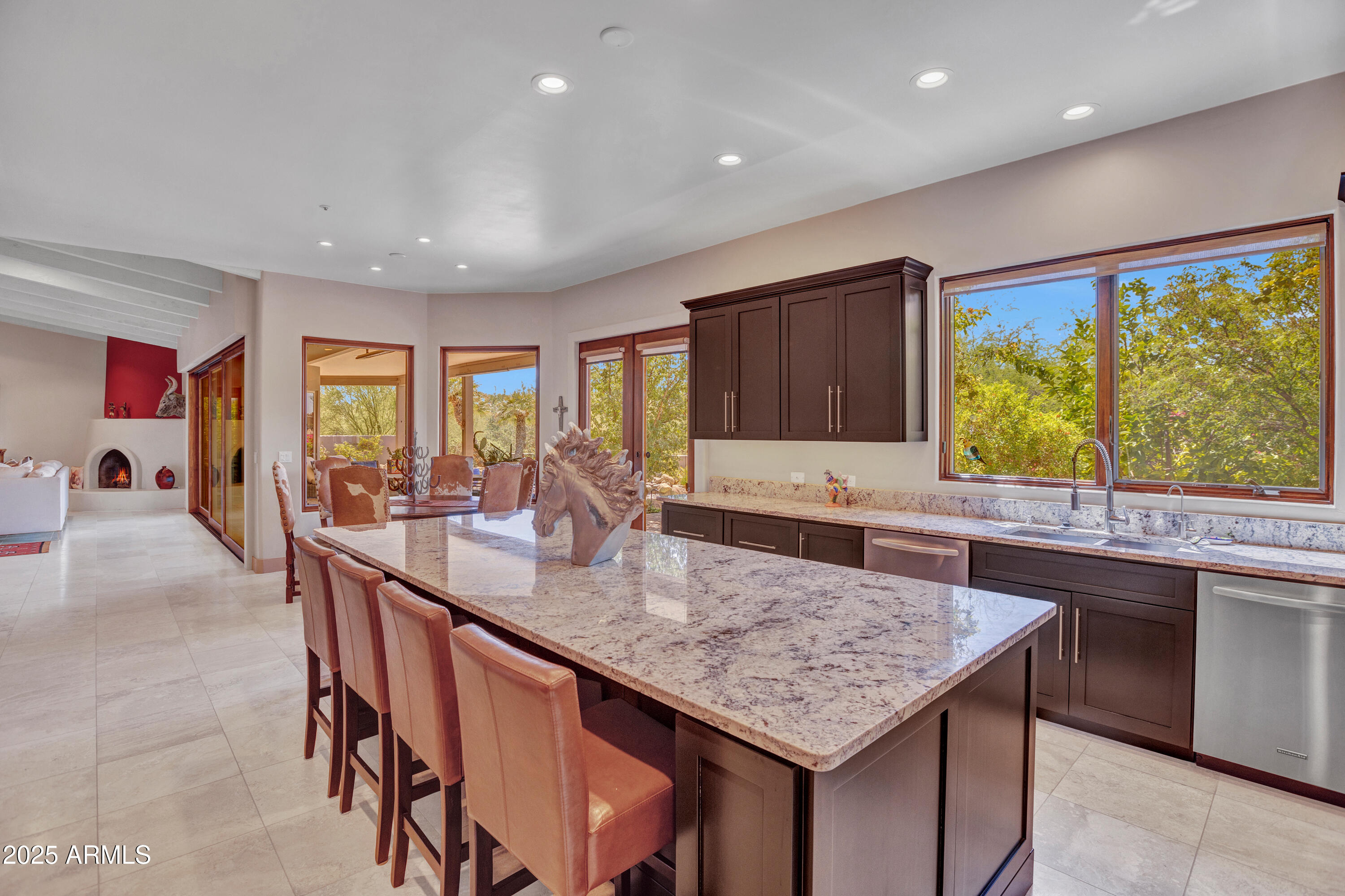 10040 East Happy Valley Road, Unit 268 Scottsdale, AZ 85255 - Photo 12 of 40 a kitchen with granite countertop kitchen island a sink and a large window