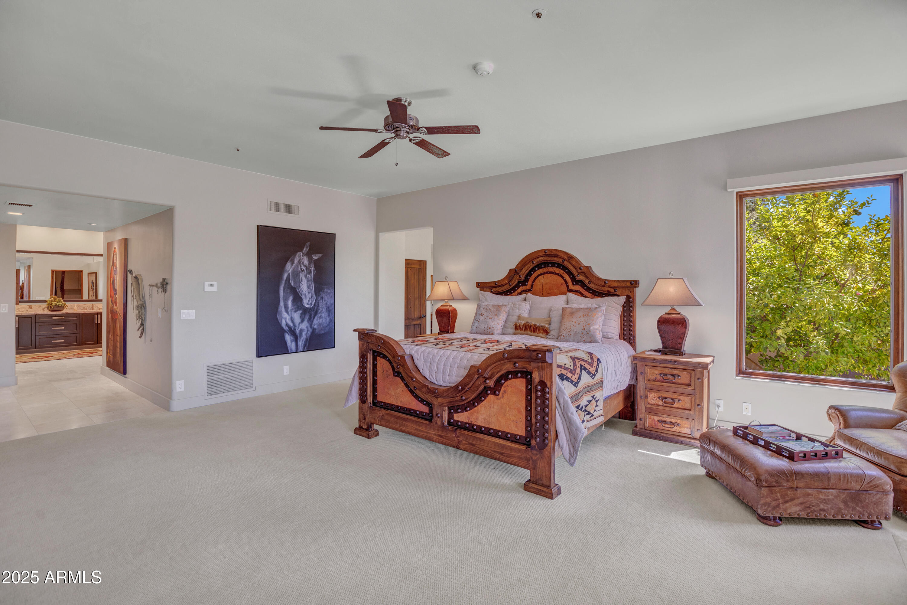 10040 East Happy Valley Road, Unit 268 Scottsdale, AZ 85255 - Photo 17 of 40 a bedroom with a bed and a chandelier