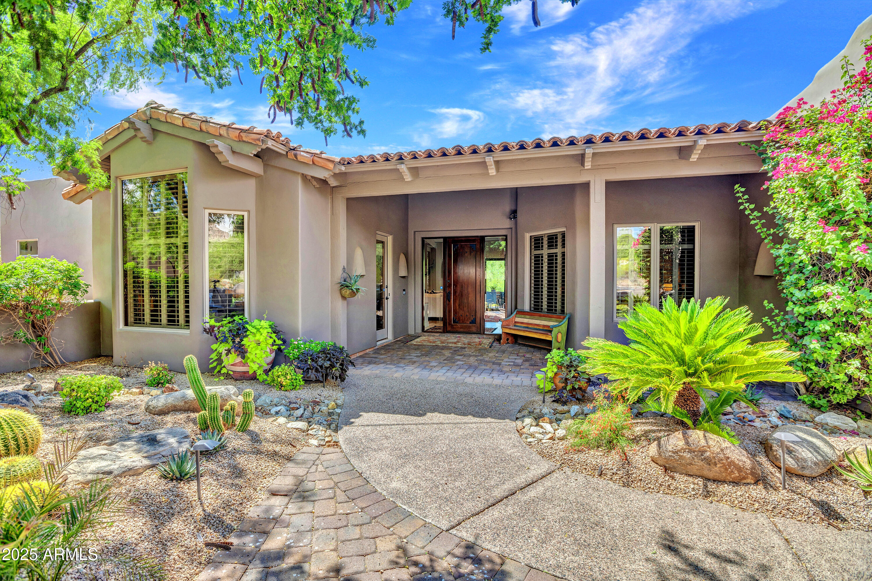 10040 East Happy Valley Road, Unit 268 Scottsdale, AZ 85255 - Photo 2 of 40 a view of a house with potted plants