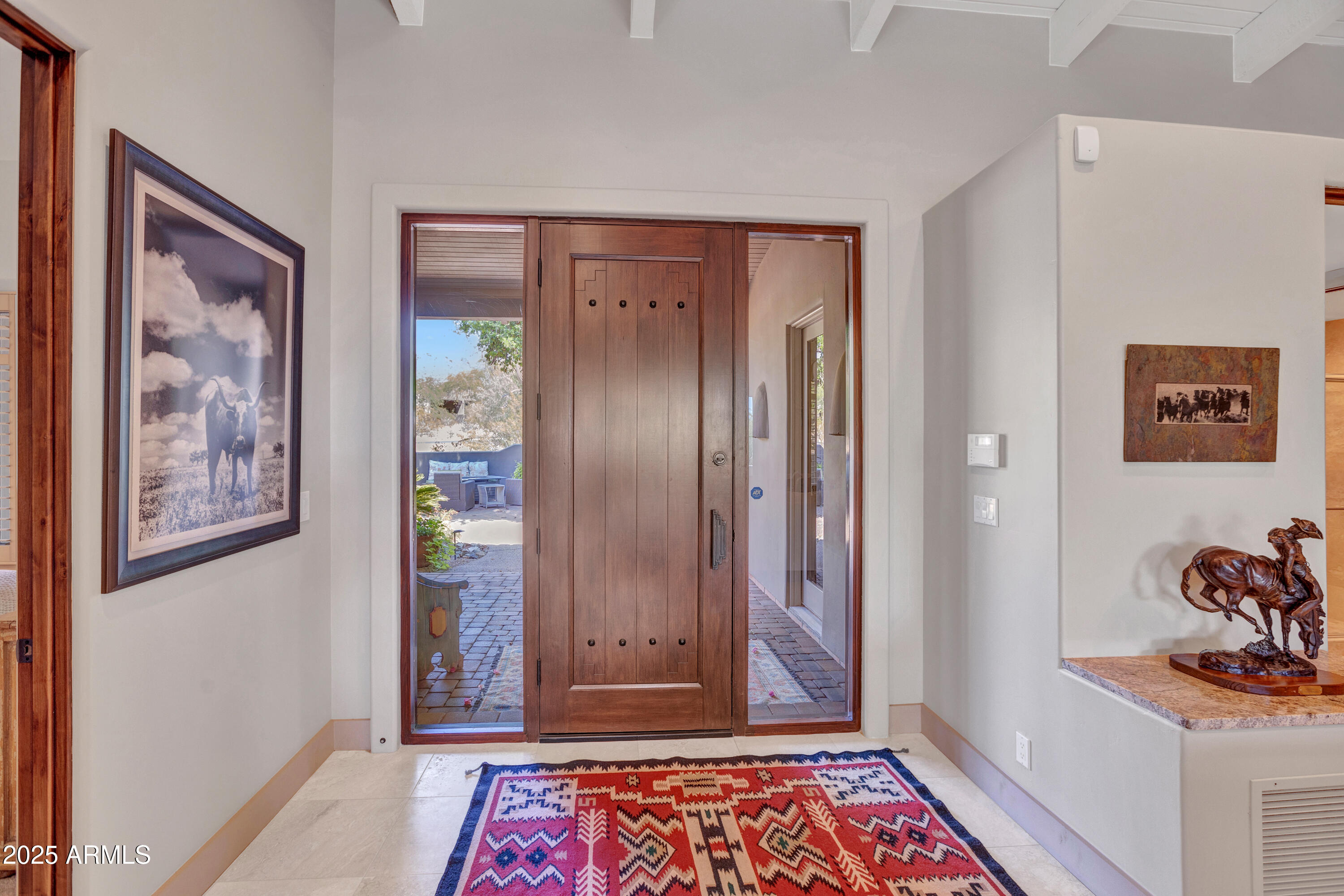 10040 East Happy Valley Road, Unit 268 Scottsdale, AZ 85255 - Photo 5 of 40 a view of a hallway with paintings on the wall