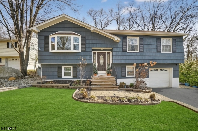 116 Star Lake Road Bloomingdale, NJ 07403 - Photo 1 of 24 a front view of a house with a yard