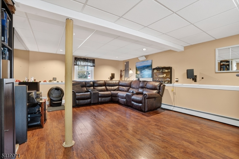 116 Star Lake Road Bloomingdale, NJ 07403 - Photo 12 of 24 a living room with furniture and a wooden floor