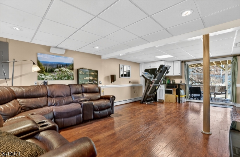116 Star Lake Road Bloomingdale, NJ 07403 - Photo 13 of 24 a living room with furniture and a flat screen tv