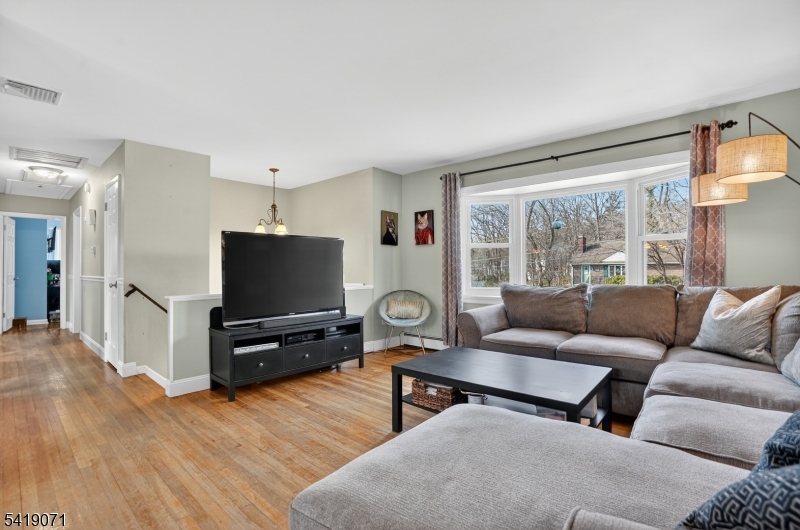 116 Star Lake Road Bloomingdale, NJ 07403 - Photo 20 of 24 a living room with furniture and a flat screen tv