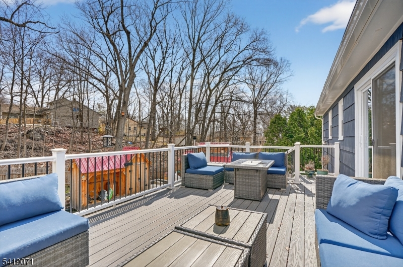 116 Star Lake Road Bloomingdale, NJ 07403 - Photo 2 of 24 a view of a deck with couches wooden floor and fence