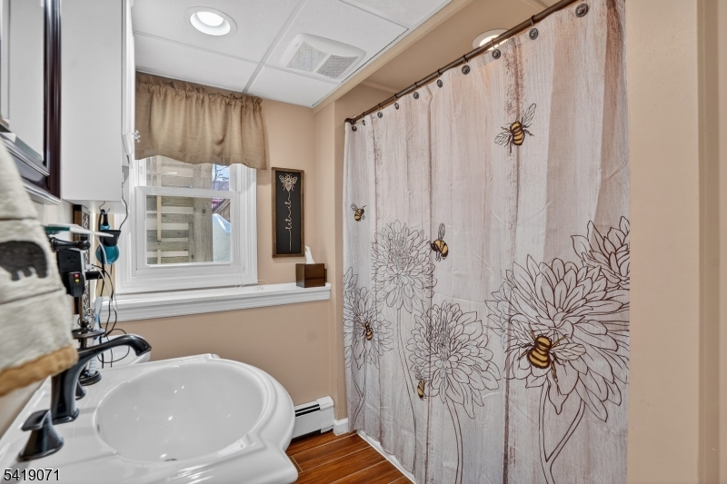 116 Star Lake Road Bloomingdale, NJ 07403 - Photo 8 of 24 a bathroom with a sink a toilet and shower