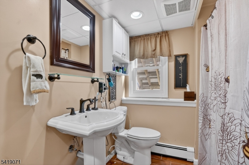 116 Star Lake Road Bloomingdale, NJ 07403 - Photo 9 of 24 a bathroom with a sink toilet and mirror