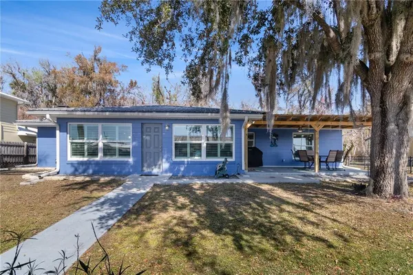 a view of a house with backyard sitting area and porch