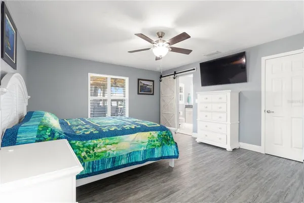 a bedroom with a bed and a chandelier