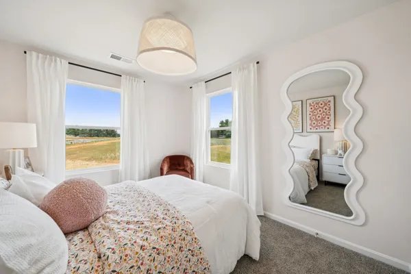 a bedroom with a large bed and a window