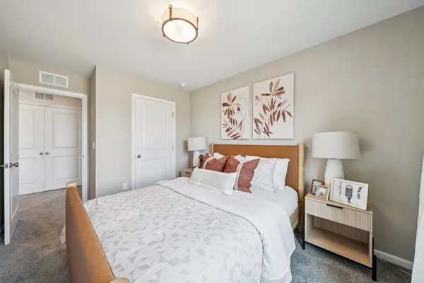 a bedroom with a bed and a lamp