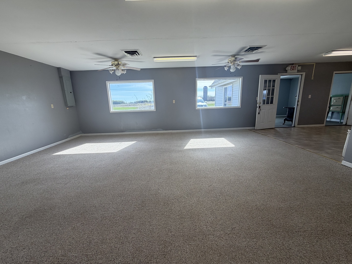 9843 Hoover Road Rock Falls, IL 61071 - Photo 7 of 23 a view of a big room with windows and chandelier