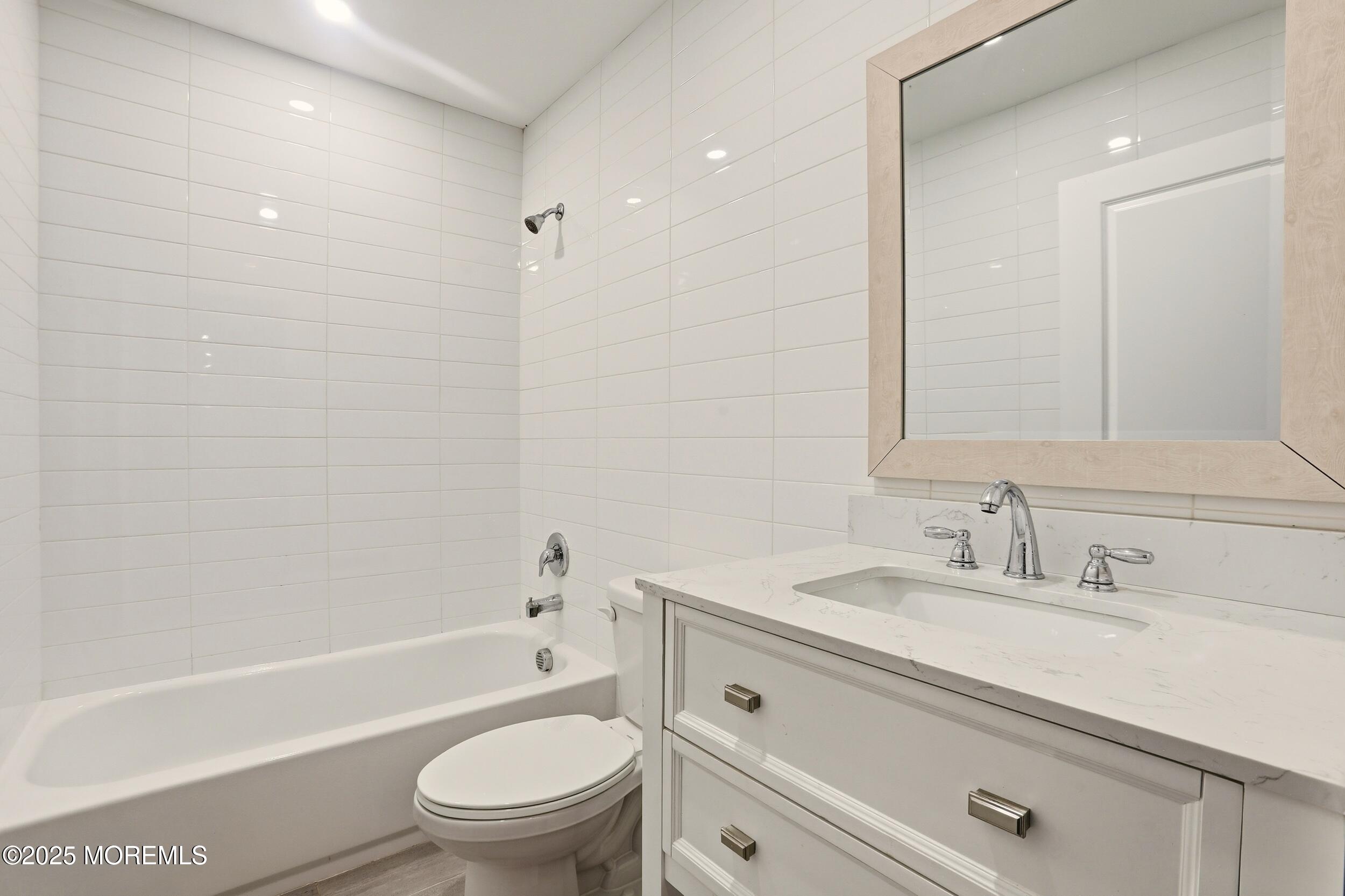 2930 Highway 9 Howell, NJ 07731 - Photo 19 of 30 a bathroom with a sink a toilet and a bathtub