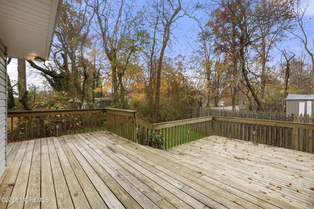 a view of balcony with wooden floor and fence