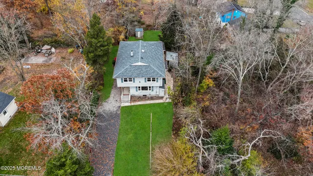 an aerial view of a house with a yard