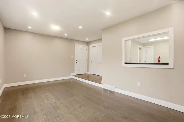 an empty room with a mirror and vanity