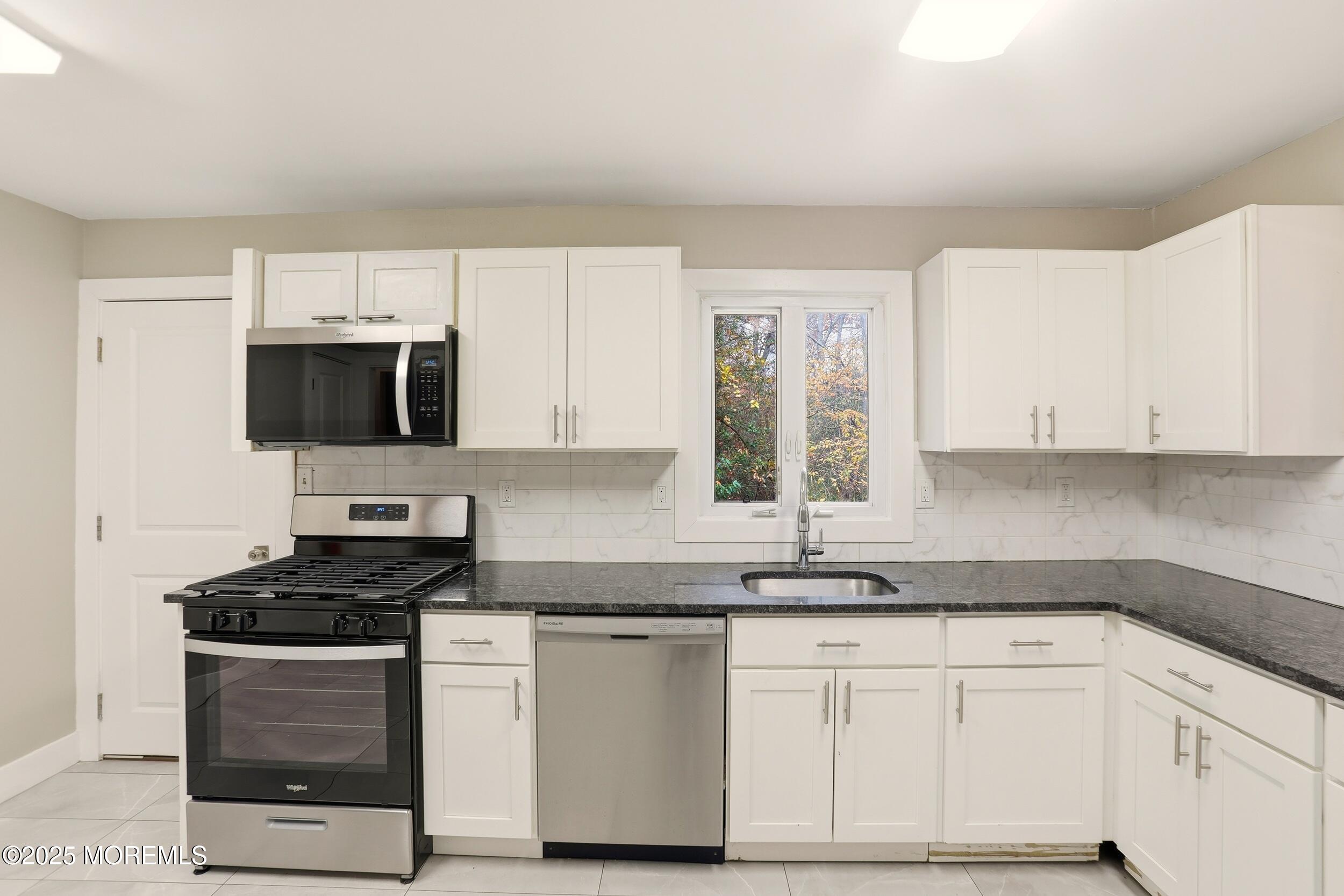 2930 Highway 9 Howell, NJ 07731 - Photo 7 of 30 a kitchen with granite countertop white cabinets and stainless steel appliances