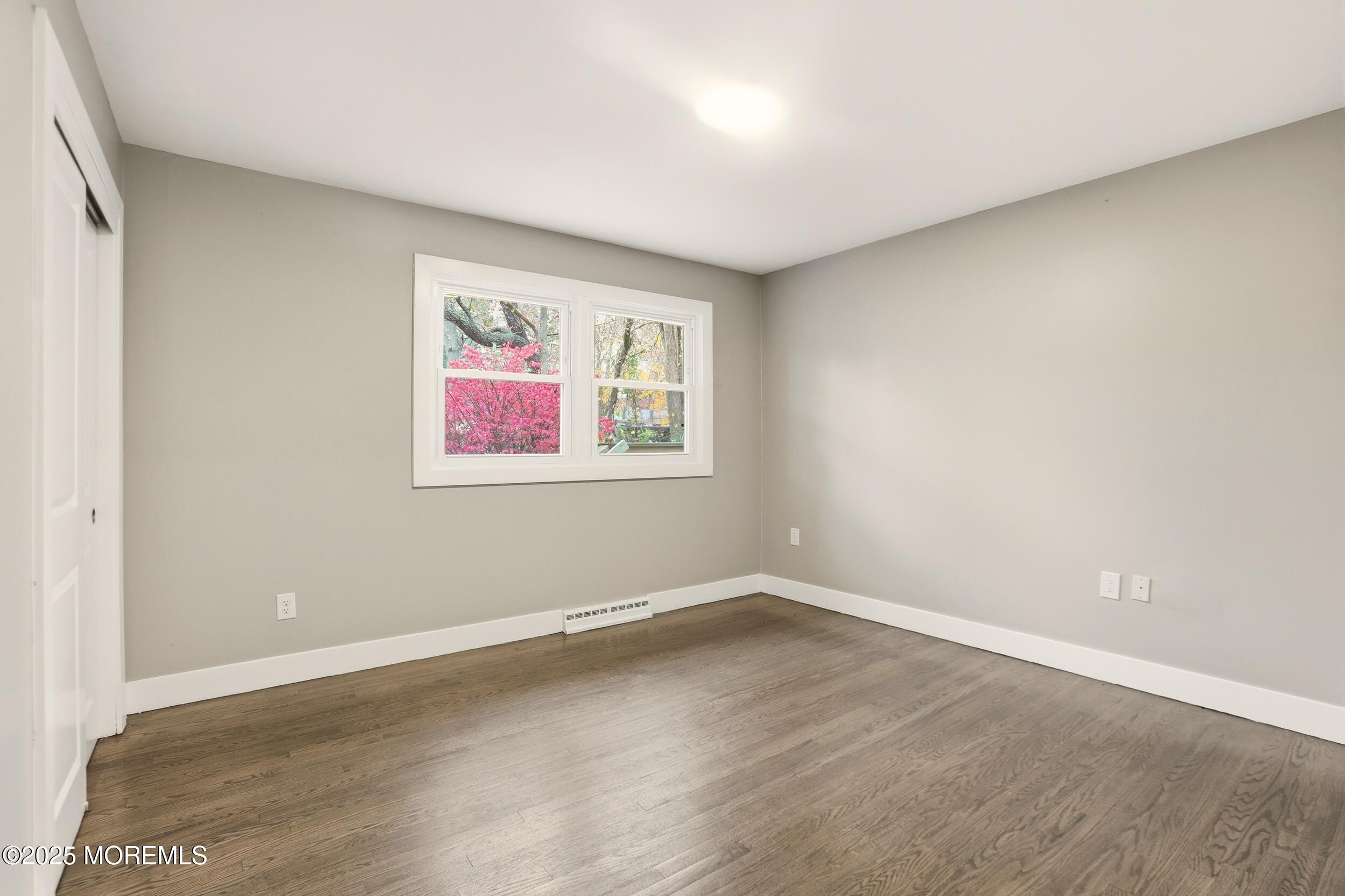 2930 Highway 9 Howell, NJ 07731 - Photo 9 of 30 an empty room with wooden floor and window