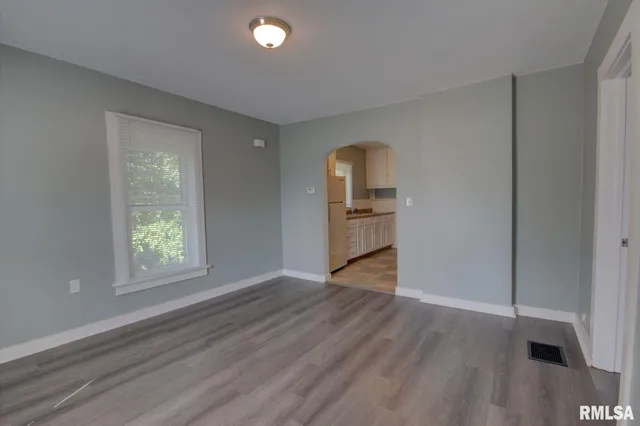 an empty room with windows and closet
