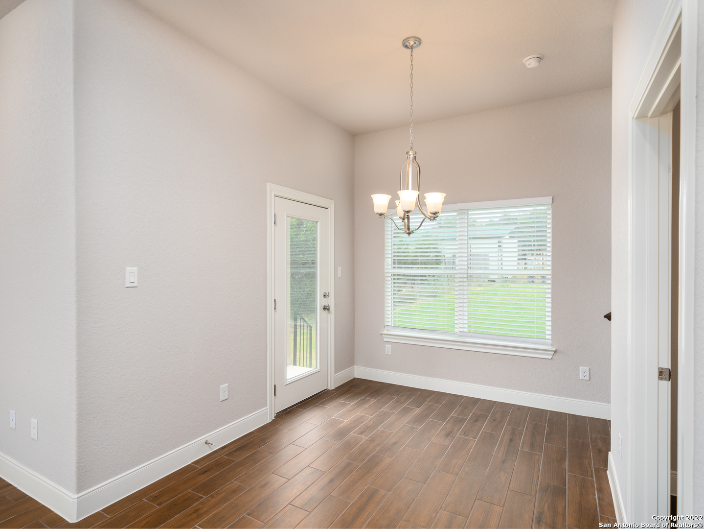 109 High Drive, Unit A Spring Branch, TX 78070 - Photo 12 of 24 an empty room with wooden floor and windows