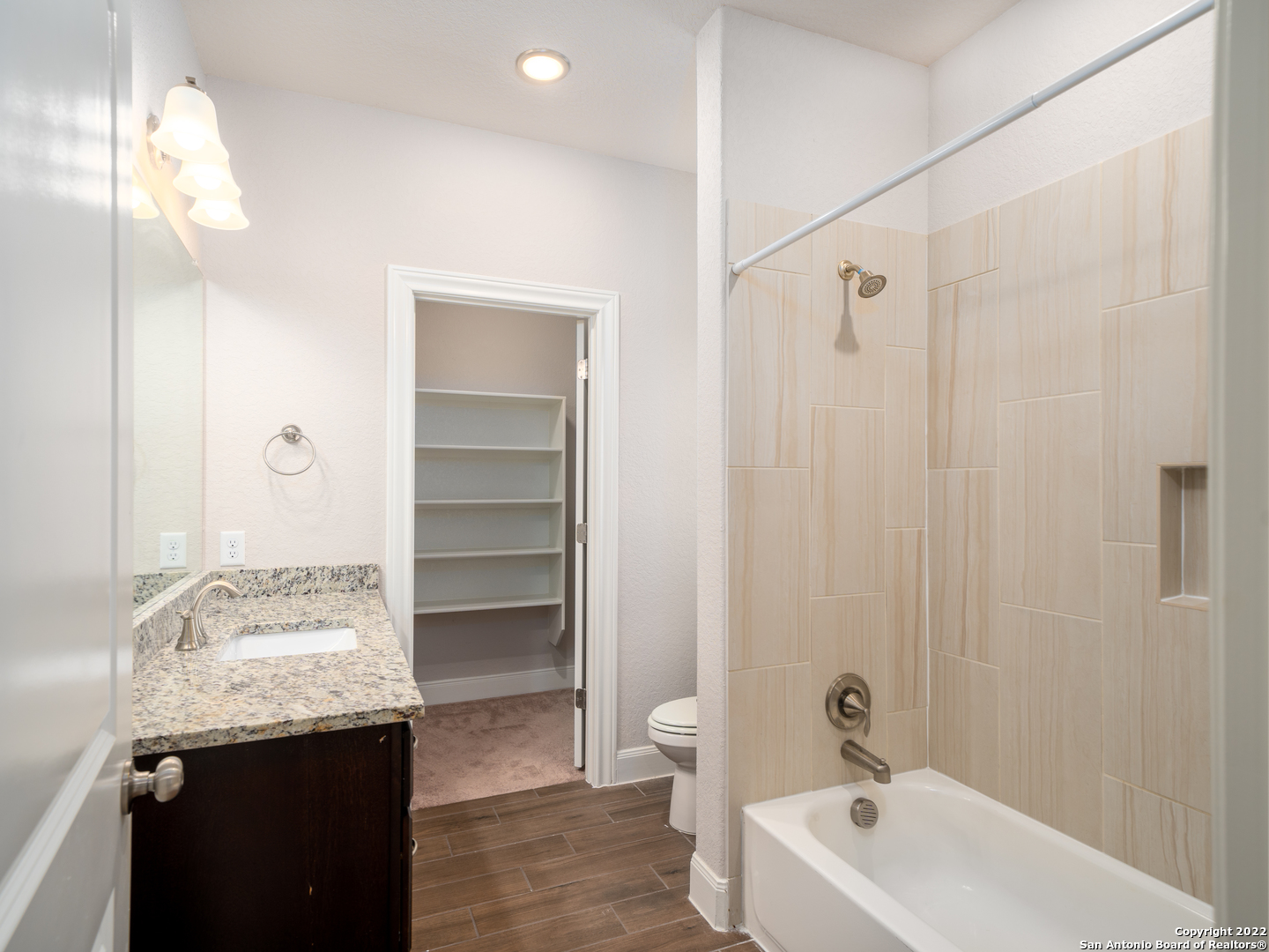 109 High Drive, Unit A Spring Branch, TX 78070 - Photo 18 of 24 a bathroom with a granite countertop sink a toilet and shower