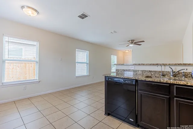 a kitchen with granite countertop a sink and a stove