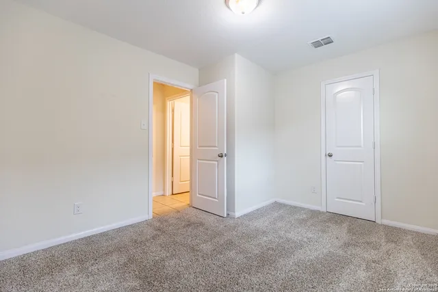 an empty room with windows and closet
