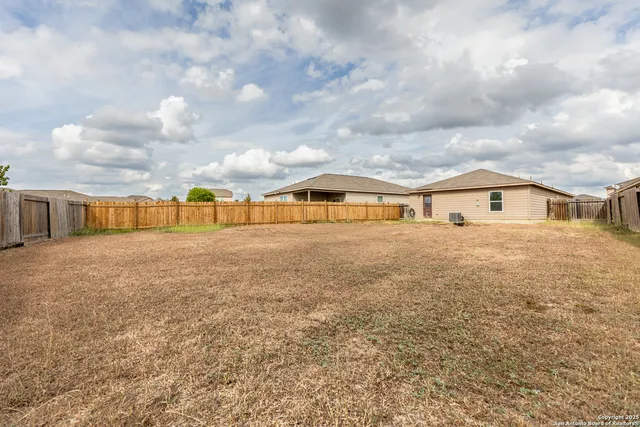 a view of house with yard and entertaining space