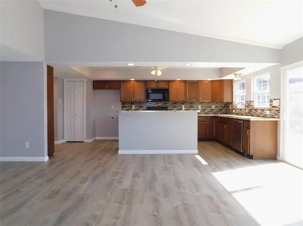 a kitchen with stainless steel appliances a stove a sink and a refrigerator
