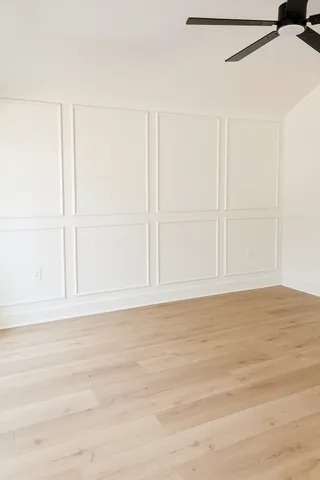 a kitchen with stainless steel appliances granite countertop a sink a stove and white cabinets