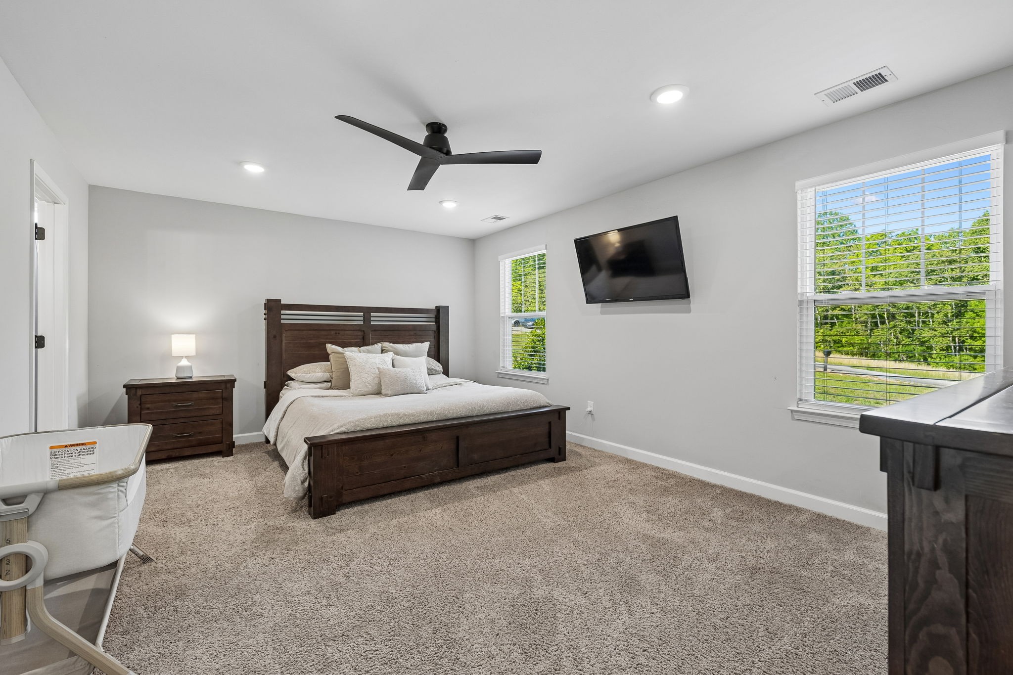 300 Still Point Road Smithville, TN 37166 - Photo 19 of 40 a spacious bedroom with a bed and a flat screen tv