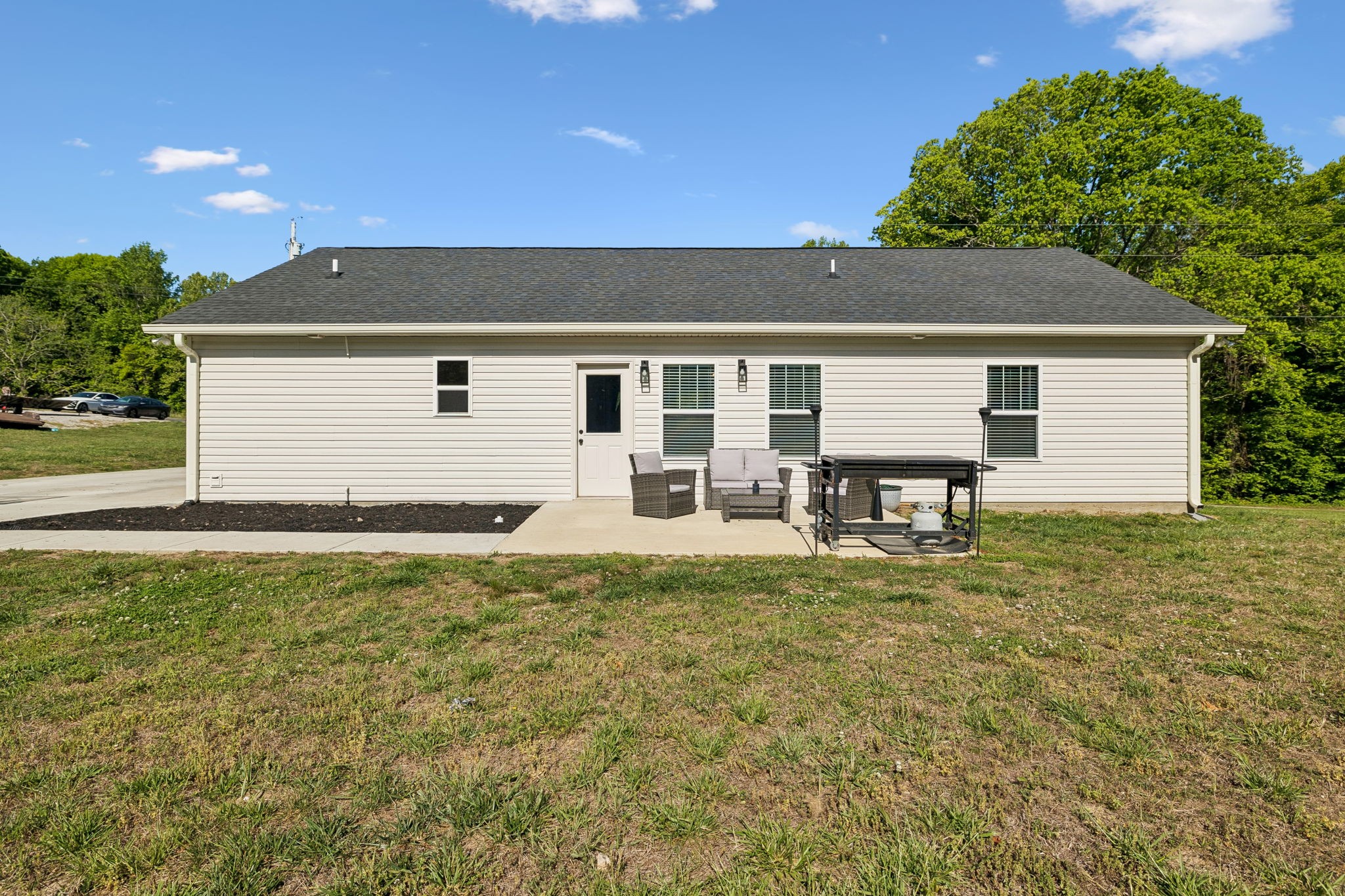 300 Still Point Road Smithville, TN 37166 - Photo 30 of 40 a backyard of a house with table and chairs