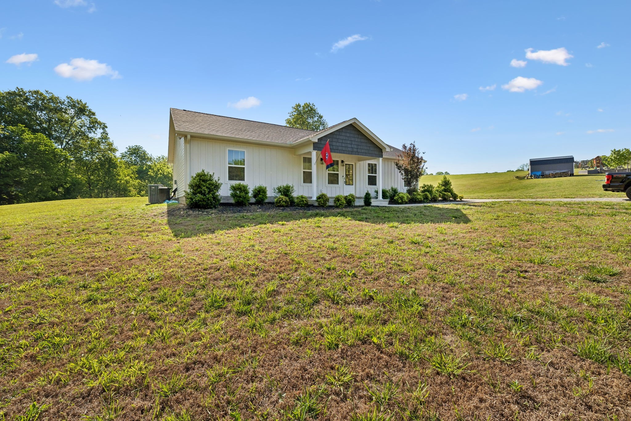300 Still Point Road Smithville, TN 37166 - Photo 3 of 40 a front view of house with yard and trees in the background