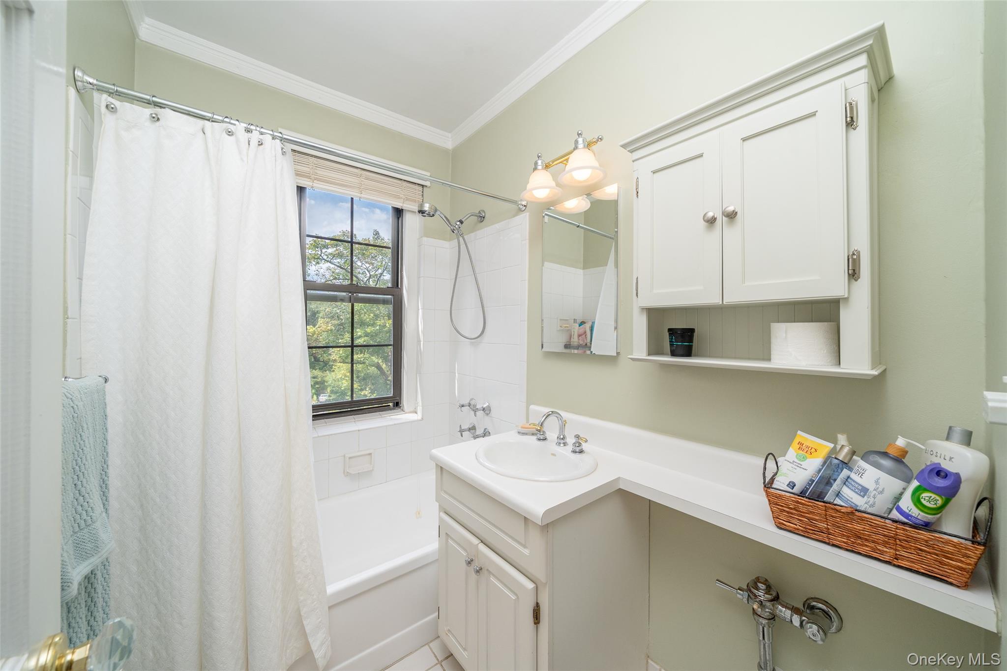 180 Garth Road, Unit 5F Scarsdale, NY 10583 - Photo 16 of 26 a bathroom with a sink mirror and a shower