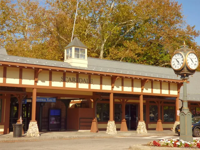 a view of a brick house with a large windows and a clock on the wall