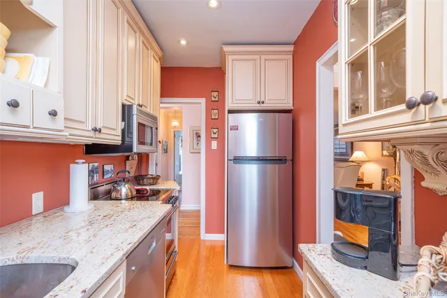a kitchen with stainless steel appliances granite countertop a refrigerator and a sink