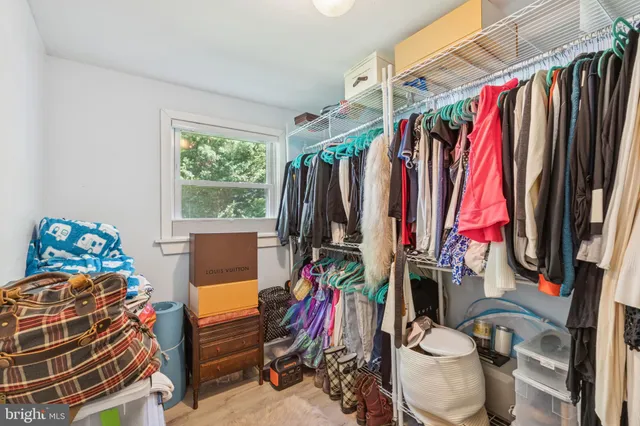 a view of walk in closet with clothes