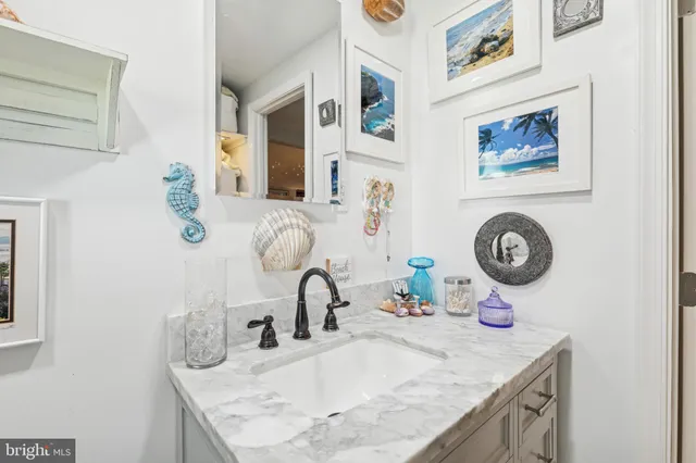 a bathroom with a granite countertop sink a toilet and a mirror