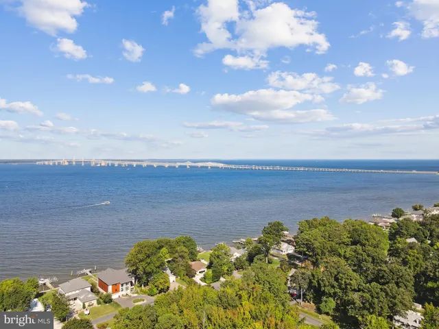 an aerial view of a house with a yard and trees