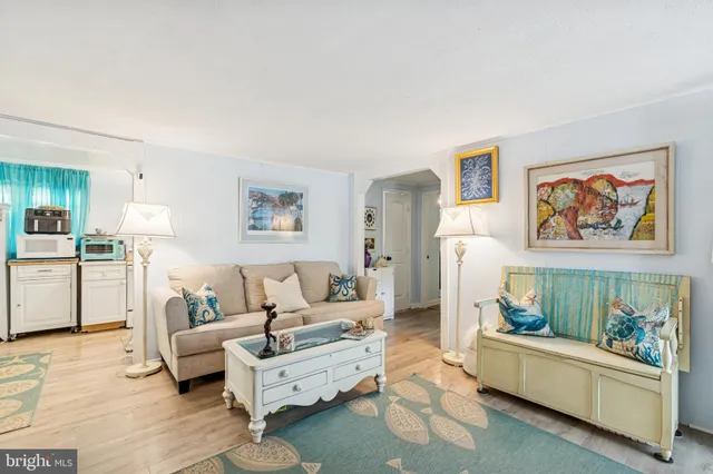 a living room with furniture and a painting on the wall