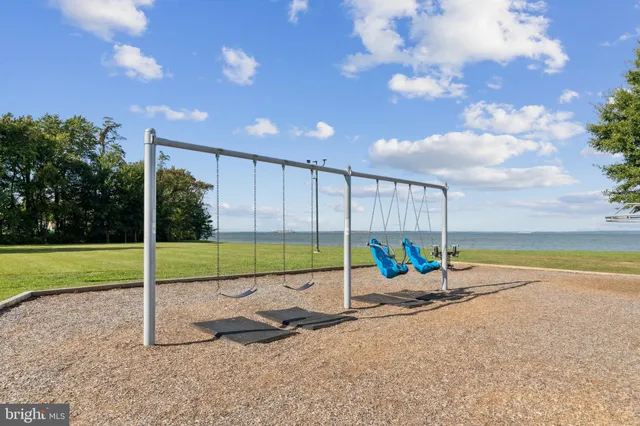 a view of a swimming pool with an outdoor seating and a yard