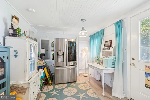 a view of kitchen with refrigerator and wooden floor