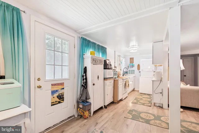 a view of a kitchen with fridge and workspace