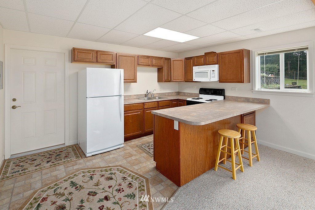 2075 East Goss Lake Road Freeland, WA 98249 - Photo 20 of 40 a kitchen with a appliances a sink and a refrigerator