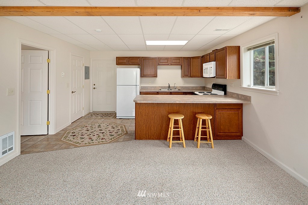 2075 East Goss Lake Road Freeland, WA 98249 - Photo 21 of 40 a living room with stainless steel appliances granite countertop furniture and a fireplace