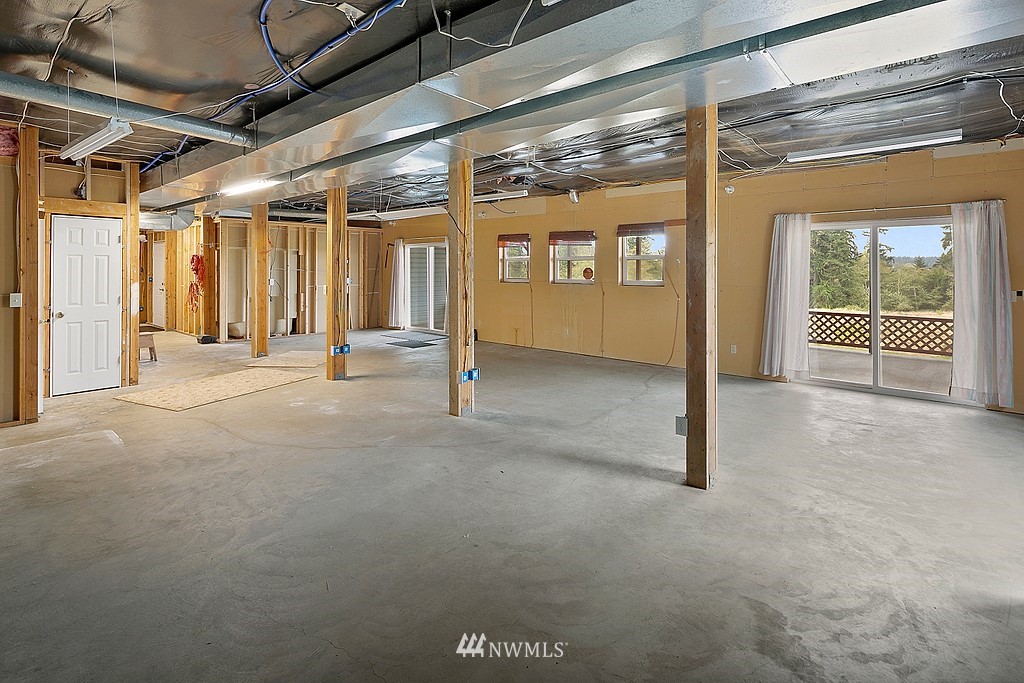 2075 East Goss Lake Road Freeland, WA 98249 - Photo 27 of 40 a view of an empty room with a sliding door